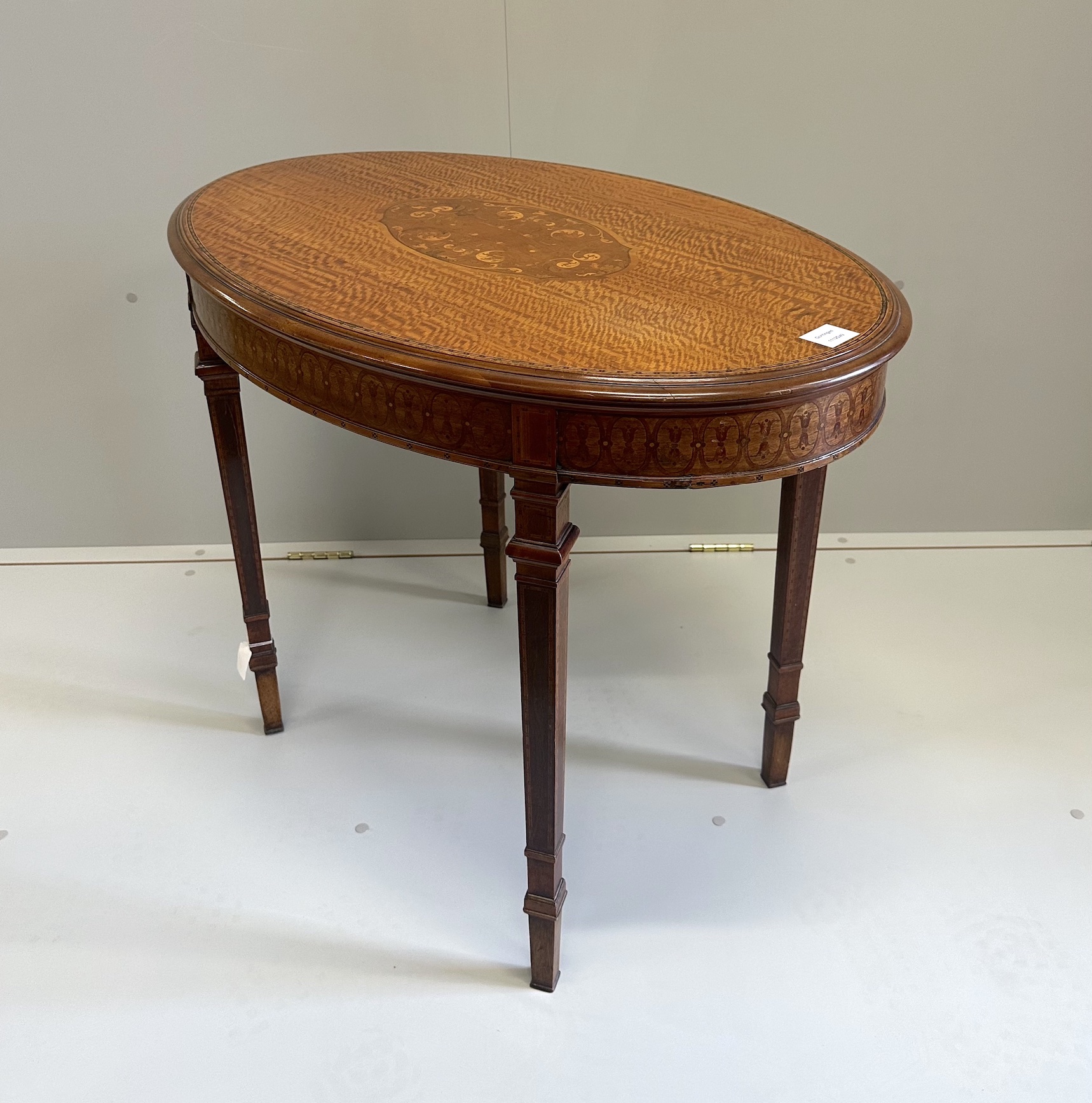 An Edwardian marquetry inlaid satinwood oval topped occasional table, width 89cm, depth 58cm, height 70cm